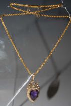 A late 19th/ early 20th century yellow metal necklace, stamped '15' suspending a yellow metal and