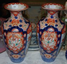 A pair of 20th century Japanese Imari pattern vases, decorated with four pictorial panels