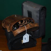 A leather cased set of vintage prism binoculars, together with two cased sets of 10 x 42 field