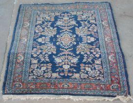 A small Persian mat with foliate design, approximately 65cm x 76cm.