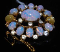 A yellow metal opal and paste set open-work oval brooch.