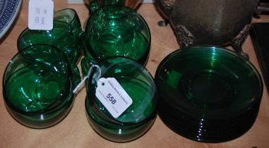 A set of eight green glass cups and saucers by Arcoroc, France.