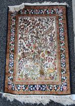 A Persian silk mat, 20th century, the beige coloured rectangular field decorated with Tree of Life