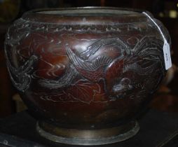 A Japanese bronzed jardiniere embossed with a central border and three phoenix birds.