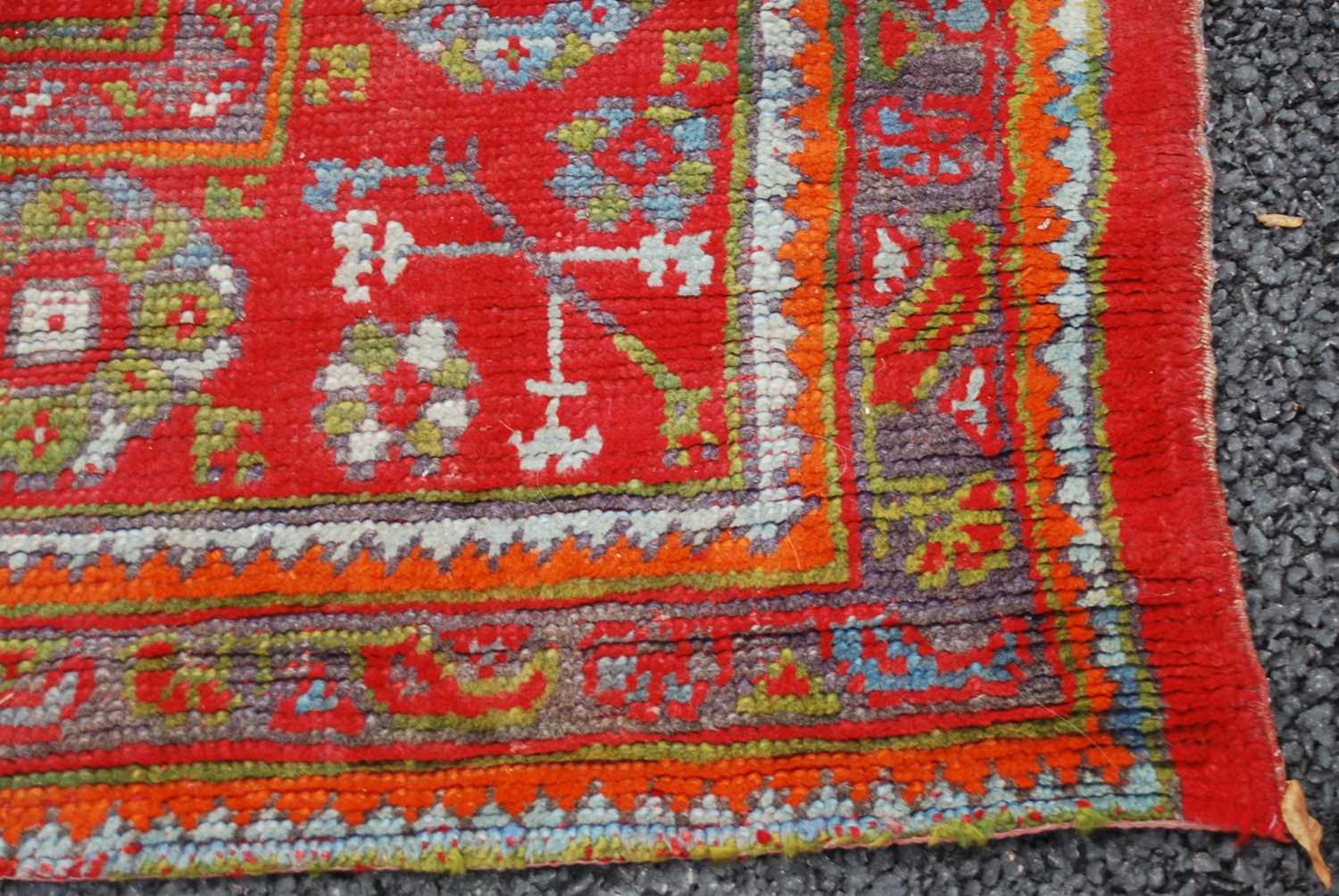 A late 19th century red ground Ushak carpet, the rectangular field decorated with three rows of - Image 4 of 9