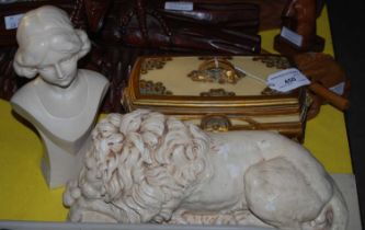 A composite trinket box with gold-coloured accents, together with a composite recumbent lion, and