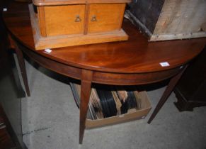 A mahogany demi lune console table, the lower edge with a band of satin and ebonised inlay, raised