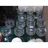 A suite of fourteen etched dessert glasses.