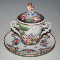 A Capodimonte porcelain twin-handled cup, cover and saucer dish with relief moulded Classical