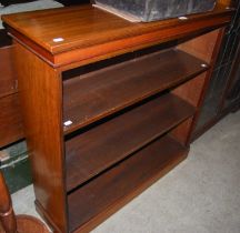 A 20th century walnut open bookcase with two adjustable shelves.