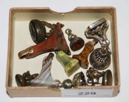 A collection of assorted white metal and hardstone seals and fobs.