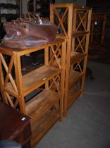 A near pair of blonde wood storage shelves together with a similar style side table with single