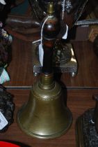 A vintage brass and turned wooden handle handbell with acorn finial, overall height 32.5cm.