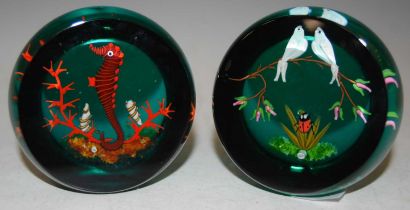 Two William Manson paperweights, one centred with a seahorse, shells and coral signed 'WM' on a