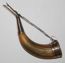 A Middle Eastern white metal mounted horn, the white metal mounts with damascened detail, the
