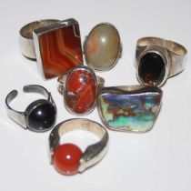 A collection of assorted white metal dress rings.