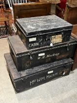 Three Japanned metal storage trunks, the two larger each with painted letters 'W.M. Mackay & Mrs W.