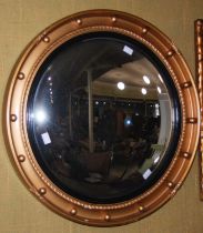A Regency style convex gilt framed wall mirror.