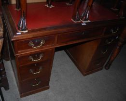 An early 20th century mahogany twin pedestal desk with red leather skiver.