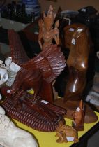 A group of carved wooden figures comprising an Indonesian style carved wooden figure of a female