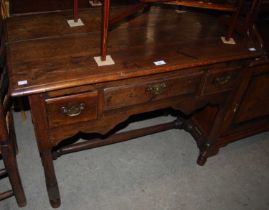 A late 18th/ 19th century oak lowboy, the central frieze drawer flanked by two short deep drawers,