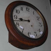 An early 20th century oak circular cased wall clock, the Arabic numeral dial with single train