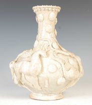A Chinese biscuit porcelain and crackle glazed bottle vase, Qing Dynasty, decorated in relief with