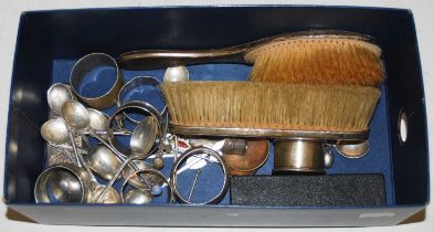 A collection of assorted silver ware to inlcude brushes, napkin rings, spoons, etc.