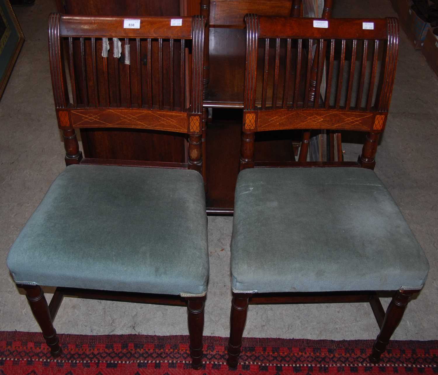 A pair of 19th century mahogany and inlaid bedroom chairs with blue velvet upholstered seats.