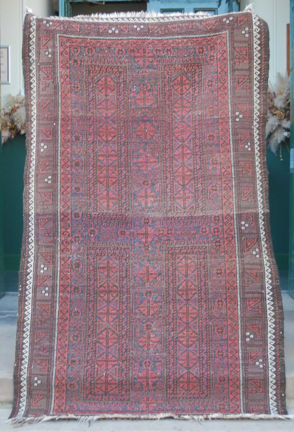 A Persian rug, early 20th century, the rectangular field centred with a cross form motif worked in - Image 2 of 5
