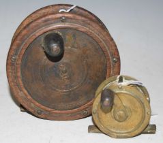 Fishing Interest - a vintage wood and brass fishing reel together with another small brass fishing