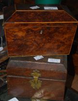 A 19th century burr walnut and inlaid sarcophagus-shaped tea caddy with lion head handles on