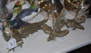 A plated figure of a pheasant together with two plated figures of cockerels.