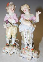 A pair of Continental porcelain figures, boy and girl flower pickers.
