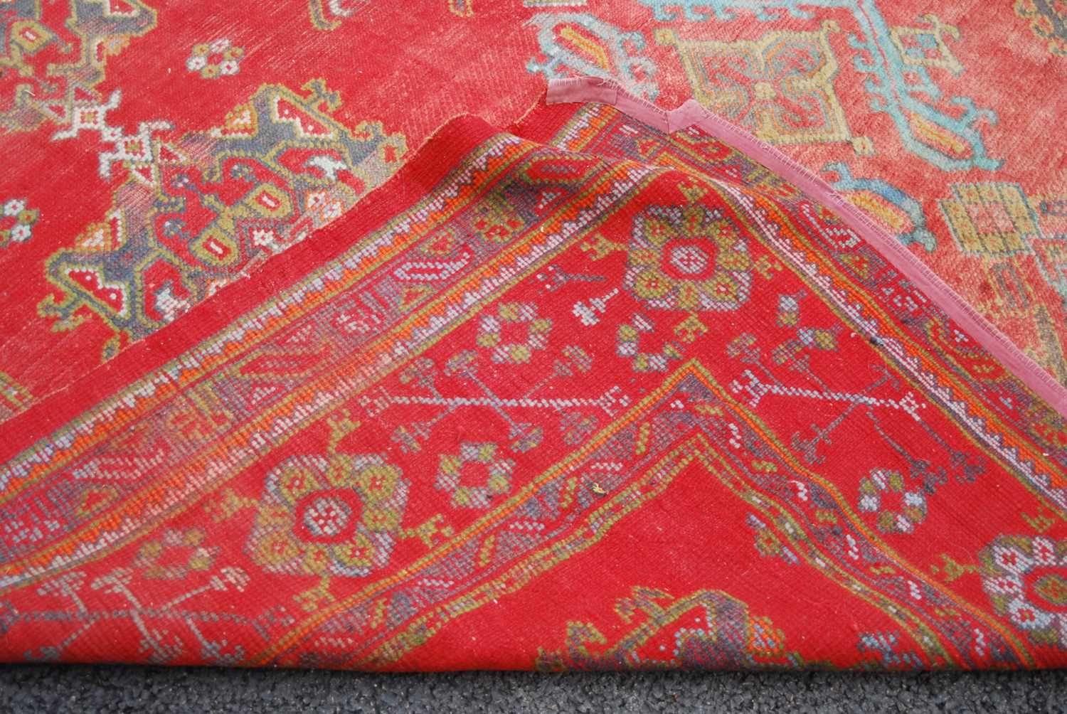 A late 19th century red ground Ushak carpet, the rectangular field decorated with three rows of - Image 8 of 9