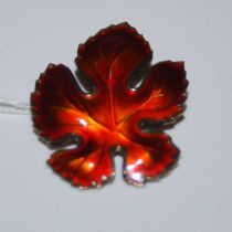 David Andersen, a Norwegian Sterling silver and red enamel brooch in the form of a leaf, 29.2mm