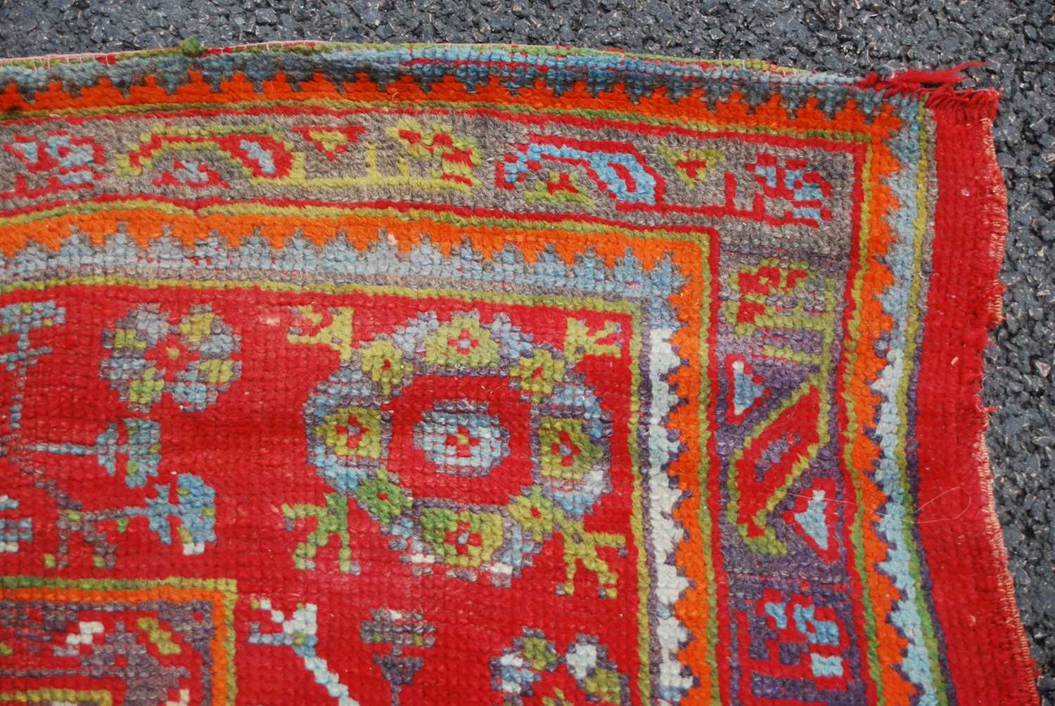 A late 19th century red ground Ushak carpet, the rectangular field decorated with three rows of - Image 3 of 9