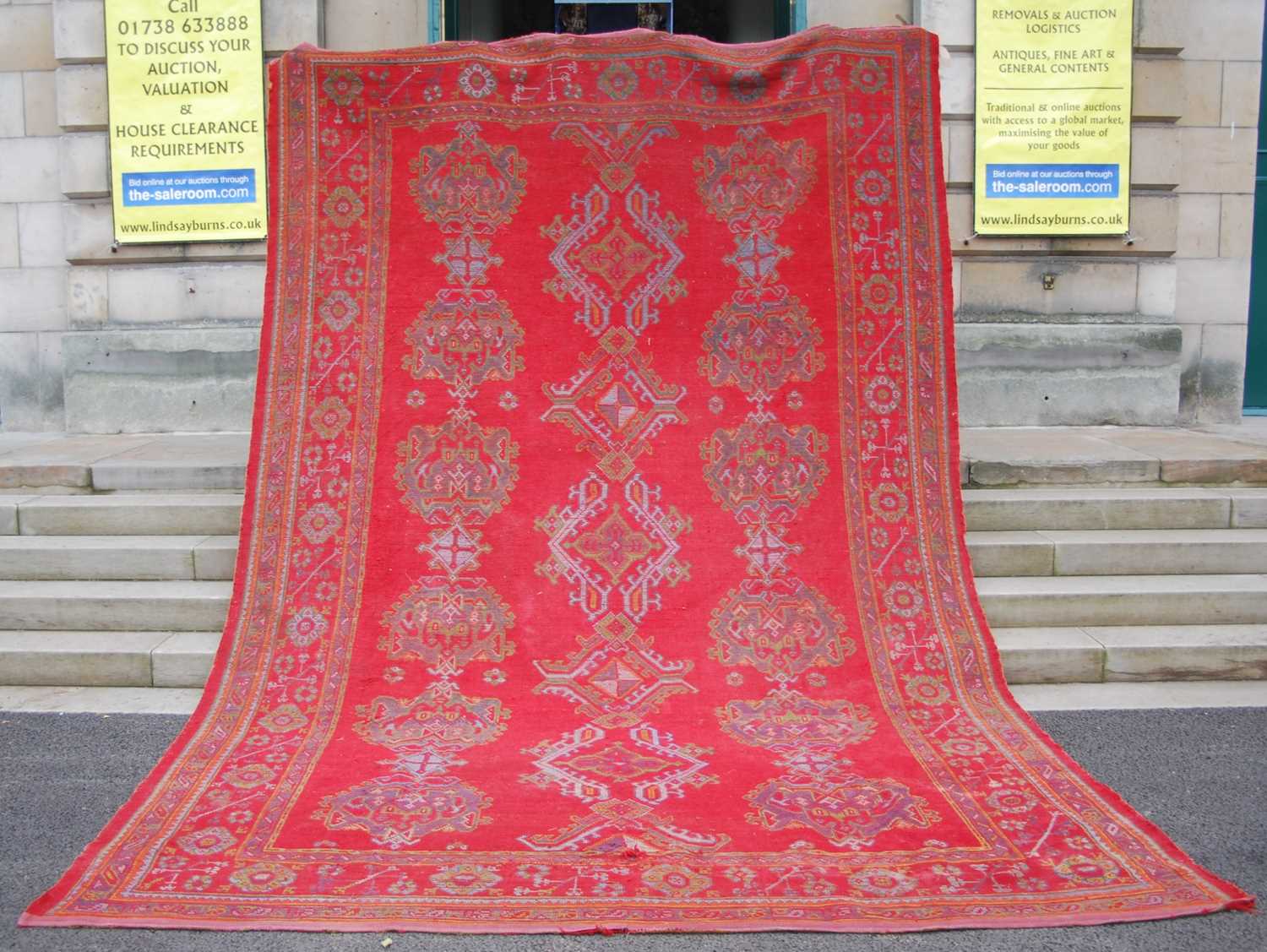 A late 19th century red ground Ushak carpet, the rectangular field decorated with three rows of - Image 2 of 9