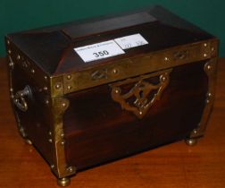 An Art Nouveau rosewood and brass-bound sarcophagus-shaped trinket box, raised on four brass bun