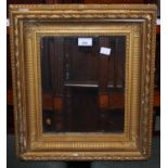 A gilt picture frame with glass panel.
