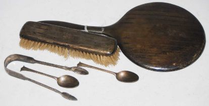 A collection of silver to include a handheld dressing table mirror, brush, pair of sugar tongs and