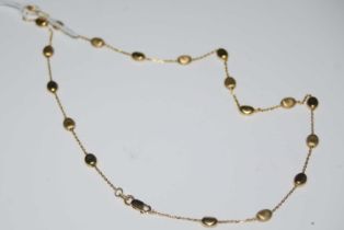 A yellow metal necklace stamped '375' set with alternating polished and matt oval ball details, 5.