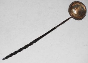 An antique white metal toddy ladle with baleen twist handle.