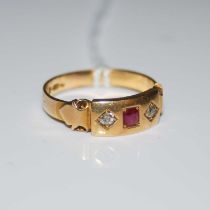 An 18ct gold ruby and diamond set three stone ring, ring size P, gross weight 3.8 grams.