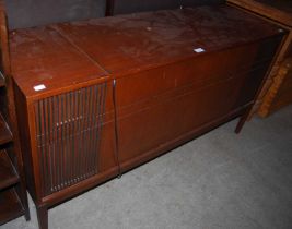 A mid-century music cabinet containing a fitted Bush Solid State stereo system and assorted 45 LPs.