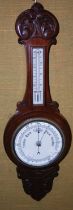 A late 19th century mahogany barometer with white coloured dials, 71cm long.