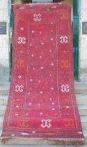 A Persian flatweave long rug, early to mid-20th century, the rectangular field centred with four
