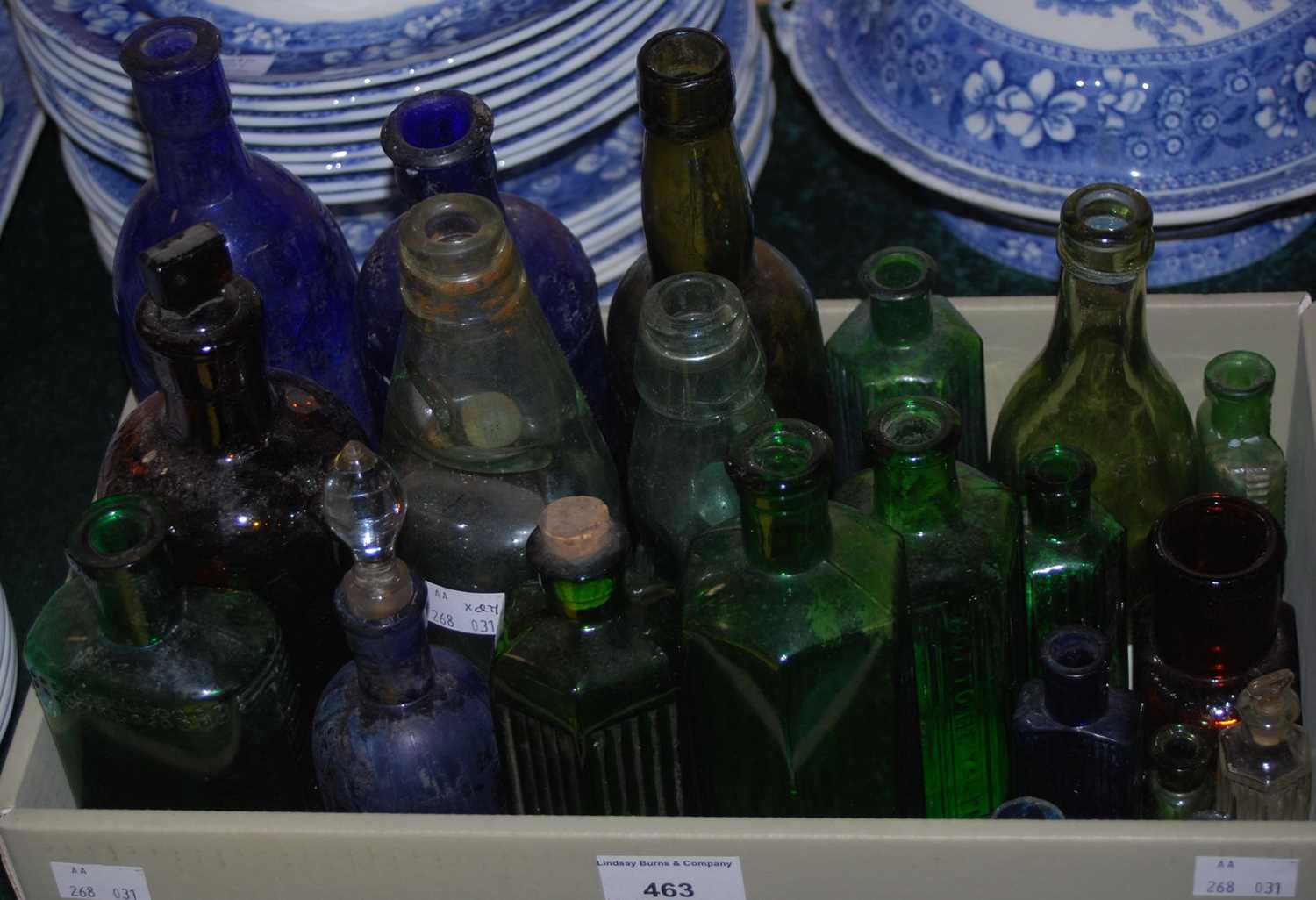 A collection of assorted coloured bottles to include a cobb-neck bottle for 'Reid Bros. Chemist