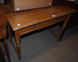 A blonde wood side table with single frieze drawer raised on four turned supports united by