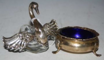 A vintage white metal mounted cut glass model of a swan with pierced and hinged wings, stamped '835'